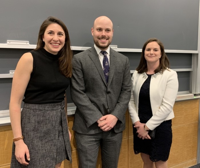 Jocelyn Hanamirian, Jack Browning, and Nathalie Russell are dressed professionally posing for a picture in a classroom